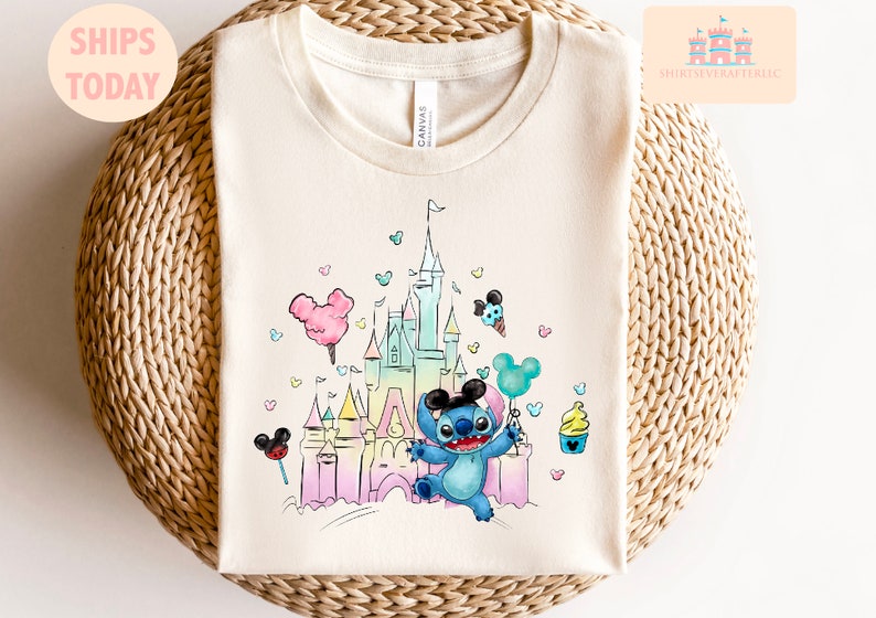 May include: A light blue Stitch character holding a balloon in front of a pastel pink and blue watercolor illustration of Cinderella's castle. The background is filled with small hearts and Mickey Mouse ears.