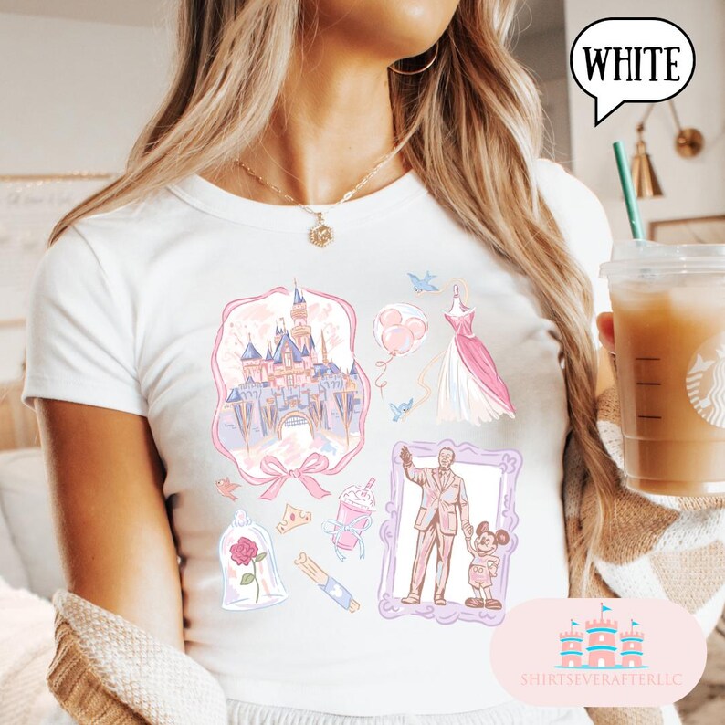 Op de afbeelding: Wit T-shirt met een kleurrijk grafisch ontwerp met een kasteel, jurk, ballonnen en andere illustraties. Het shirt heeft het woord "WHITE" in een tekstballon. Het shirt heeft ook de tekst "SHIRTSEVERAFTERLLC".