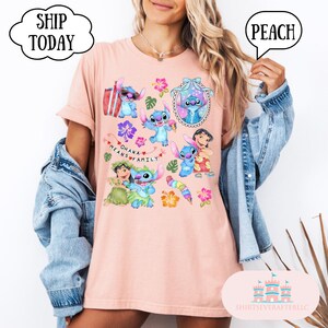 May include: Peach colored t-shirt with a graphic print of Stitch and other characters from the Disney movie Lilo & Stitch. The text "Ohana means family" is printed on the shirt.