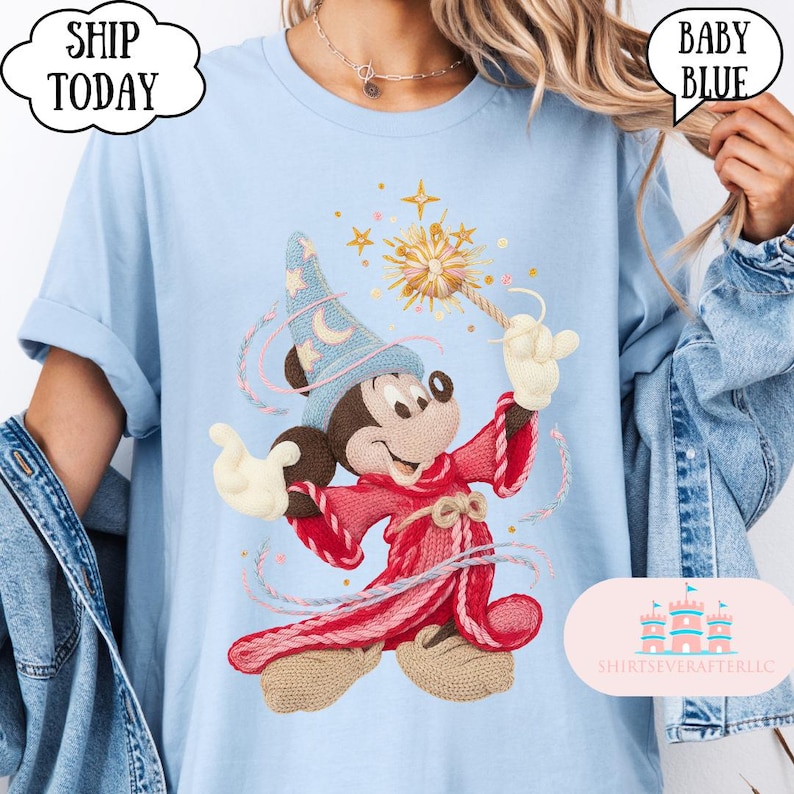 May include: Pale blue t-shirt with an embroidered Mickey Mouse design as a sorcerer, holding a wand with stars. The shirt has the text "SHIP TODAY" and "BABY BLUE" in speech bubbles. The brand name "SHIRTSEVERAFTERLLC" is also visible.