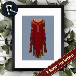 May include: Cross-stitch pattern of a red and gold cape on a light blue background, framed in black. The image includes the text "3 Sizes Included" on a red banner. A logo with a sword and the letter "R" is in the upper left corner.