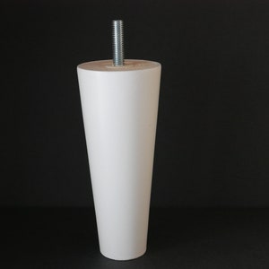 May include: White wooden furniture leg with a metal screw. The leg is tapered and has a smooth finish.