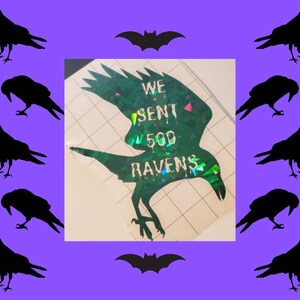 May include: A green iridescent vinyl decal of a raven with the text "We sent 500 ravens" on it.