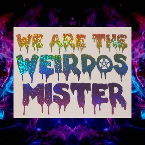 May include: A holographic sticker with a rainbow gradient. The sticker says "We are the Weirdos Mister" with a pentagram symbol in the word "Weirdos".
