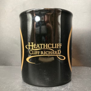 Vintage 1996 Cliff Richard Heathcliff the Musical black ceramic mug made in England
