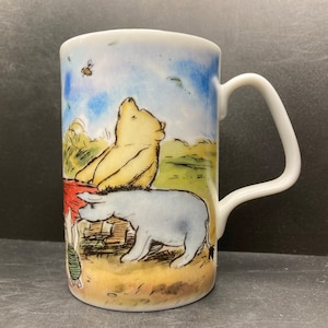 Vintage Disney Store Winnie the Pooh Eeyore Christopher Robin & Piglet holding stretched blanket beneath tree porcelain mug