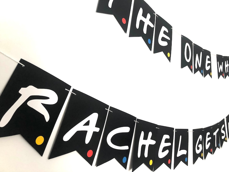 May include: Black and white banner with the text "The One Where Rachel Gets Married" in a white font. The banner is decorated with colorful dots.