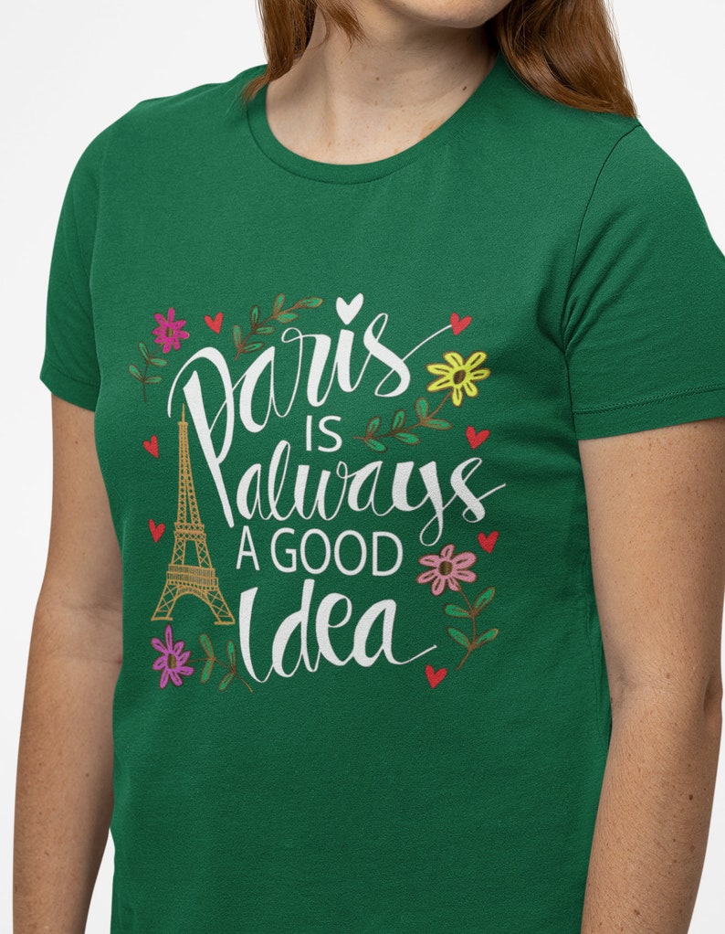 May include: Green t-shirt with a white graphic that says "Paris is always a good idea" with a drawing of the Eiffel Tower and flowers.