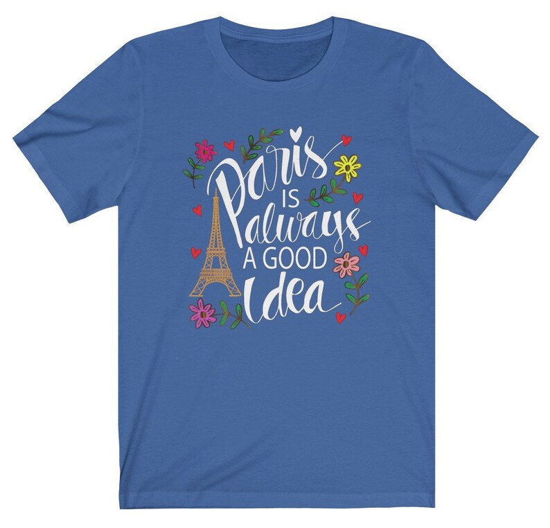 May include: A royal blue t-shirt with a white graphic design featuring the Eiffel Tower and the text "Paris is always a good idea" surrounded by flowers and hearts.