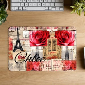 May include: Rectangular mousepad with a collage design featuring the Eiffel Tower, red roses, and vintage postage stamps. The name "Chloe" is written in cursive. The color scheme includes red, beige, and black.