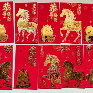 May include: A collection of red envelopes with gold foil horse and cartoon designs. The envelopes feature Chinese characters and are likely used for special occasions like Lunar New Year. The designs include horses in various poses and a cute cartoon horse.