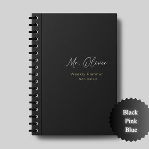May include: Black weekly planner with a spiral binding. The cover has the text "Mr. Oliver Weekly Planner Non.Dated" in white lettering.
