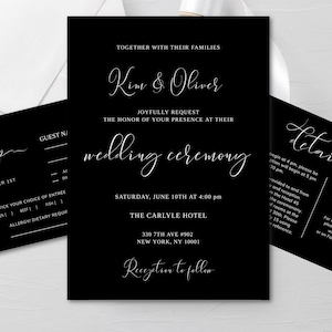 May include: Black and white wedding invitation with the names Kim & Oliver, the date Saturday, June 10th at 4:00 pm, and the location The Carlyle Hotel, 330 7th Ave #902, New York, NY 10001. The invitation also includes the text "Joyfully Request the Honor of Your Presence at Their Wedding Ceremony" and "Reception to Follow".