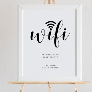 May include: White sign with black text and a wifi symbol. The text reads "wifi" and includes the network name "FOREVERLOVE" and the password "SCOTT'S FAMILY".