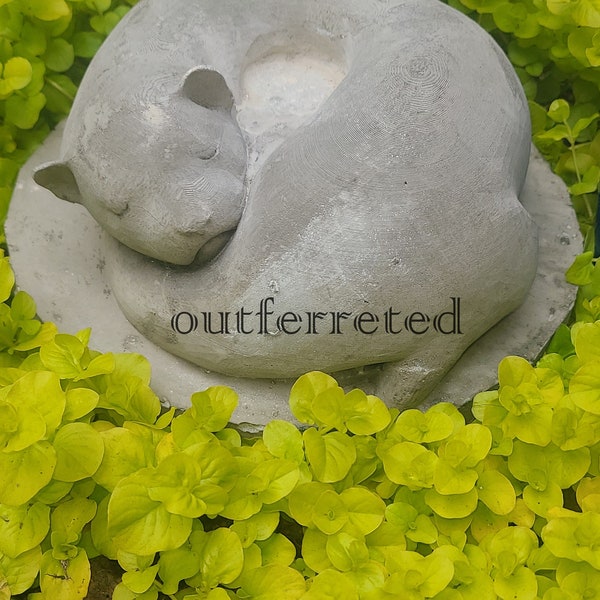 Huge concrete ferret memorial grave marker