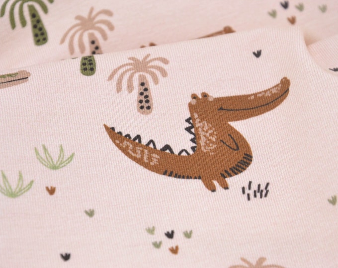 Children's jersey with crocodiles in green on beige - 150 cm wide - fabric patterned animals