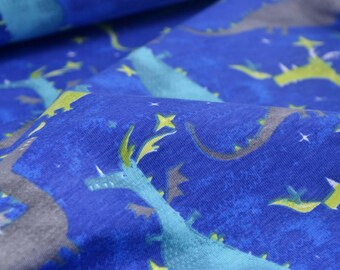 May include: Blue fabric with a repeating pattern of green and gray dragons flying through a starry night sky.
