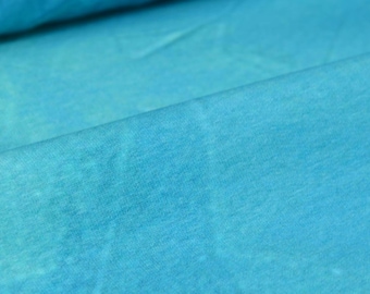 May include: A close-up of a light blue fabric with a slightly textured surface.