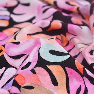 Jersey fabric made of viscose with leaves in pink, orange, and purple - 150 cm wide - smooth, patterned fabric