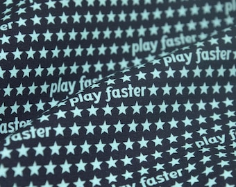 Children's jersey in black with turquoise stars, made of cotton - 150 cm wide - two-tone patterned fabric