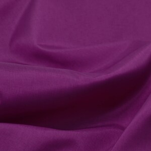 May include: A close-up of a smooth, deep purple fabric with soft folds and wrinkles.