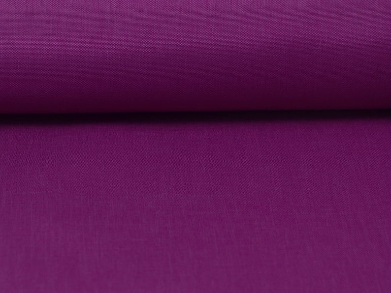 May include: Close-up of a deep purple fabric with a smooth, slightly textured surface.