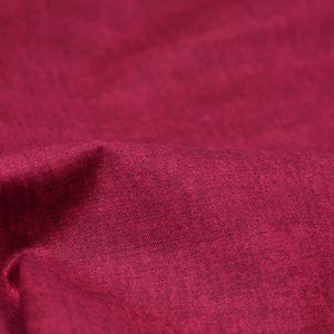 Könnte beinhalten: Nahaufnahme eines tief roten Stoffes mit einer strukturierten Oberfläche.