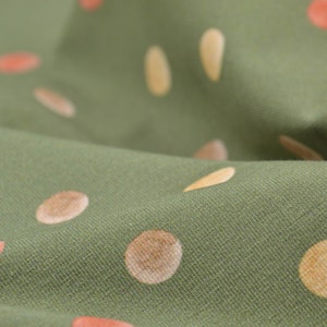 Children&#39;s jersey in green with dots, orange, yellow, made of cotton - 145 cm wide - fabric matt, dots