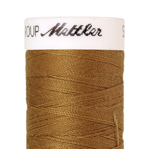 May include: A spool of brown thread with the text "GROUP Mettler" on the label.