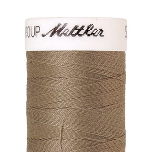 Peut inclure: Une bobine de fil brun avec le texte "GROUP Mettler" sur l'étiquette.