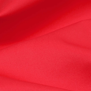 May include: A close-up of a bright red fabric with a subtle texture. The fabric is smooth and appears to be made of a high-quality material.