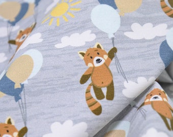 May include: A gray fabric with a repeating pattern of red pandas holding blue, beige, and white balloons. The pandas are brown with white markings and have a striped tail. The background is a light gray with white clouds.
