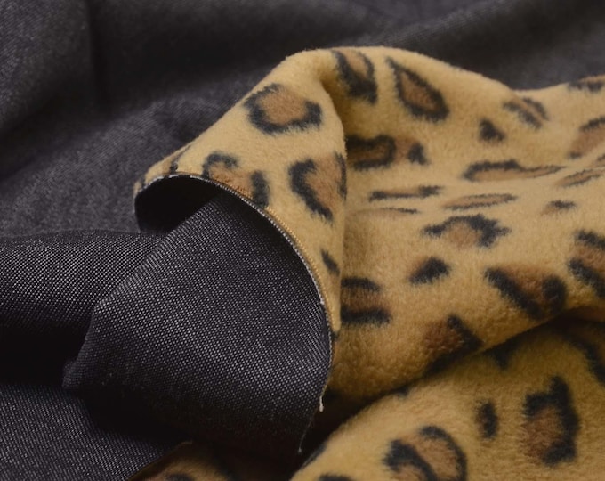 Jacket fabric made of denim with a fleece backing featuring a leopard print, black - 140 cm wide - matte fabric, leopard print