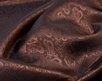 May include: Brown paisley patterned fabric with a soft, textured surface.