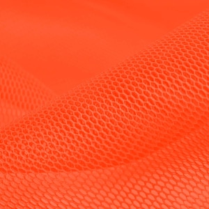 May include: Close-up of a bright orange mesh fabric with a textured pattern. The fabric is soft and flexible, with a slight sheen.