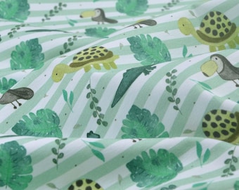 May include: White fabric with green stripes and a repeating pattern of toucans, turtles, and tropical leaves.