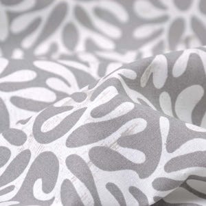 May include: Gray fabric with a white abstract pattern of organic shapes. The fabric has a textured surface.