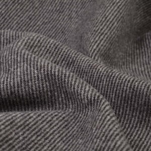 May include: Close-up of a grey and black striped fabric with a textured surface.