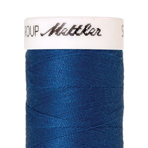 May include: A spool of blue thread with a white label that reads "GROUP Mettler".