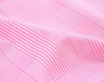 May include: Pink and white checkered fabric with a subtle houndstooth pattern. The fabric is soft and smooth, and it has a slight sheen.