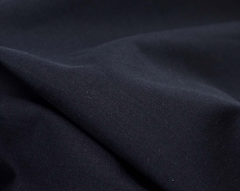 May include: Close-up of a dark blue fabric with a smooth, textured surface.