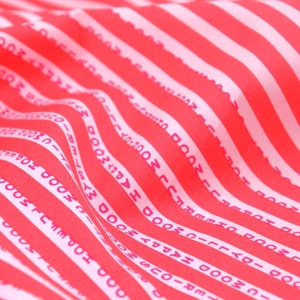 May include: Red and white striped fabric with the text "HAPPY MOOD" repeated in pink.