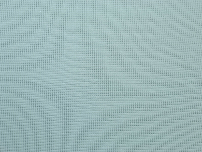 May include: A light blue textured fabric with a subtle grid pattern.