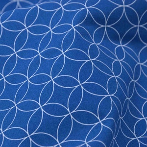 May include: Blue fabric with a white geometric pattern of overlapping circles.