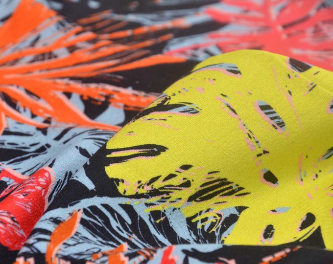 Jersey fabric made of viscose with large leaves in pink, red, yellow, and black - 160 cm wide - smooth, patterned fabric