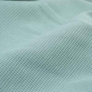 May include: A close-up of a light blue textured fabric. The fabric has a subtle waffle weave pattern.