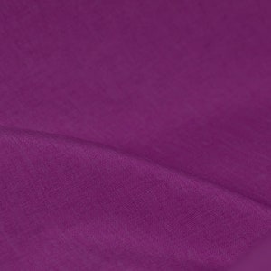 May include: A close-up of a deep purple fabric with a smooth, textured surface.