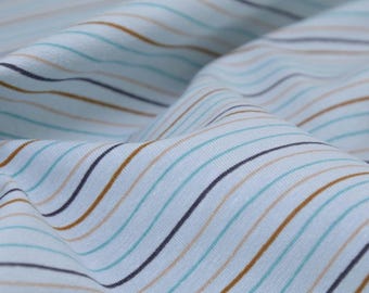May include: Close-up of a light blue fabric with thin brown, blue, and white stripes. The fabric is wrinkled and has a soft texture.