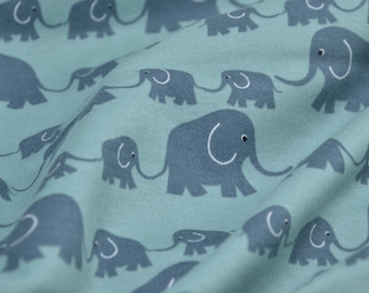 May include: A teal fabric with a repeating pattern of gray elephants holding the trunks of smaller gray elephants. The elephants have white outlines and black eyes.