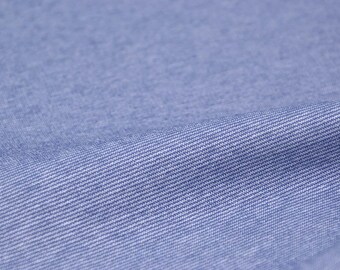 Pode incluir: Close-up de um tecido azul claro com uma textura sutil tecida.